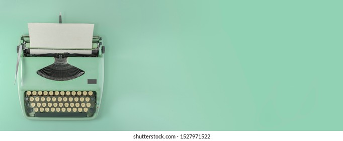 A green vintage typewriter with green background.