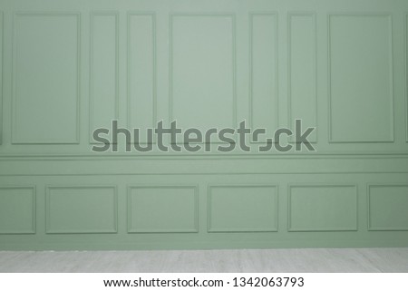 A green wall with wainscoting background 