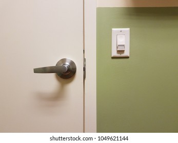 Green Wall With White Door And Motion Sensor Light Switch