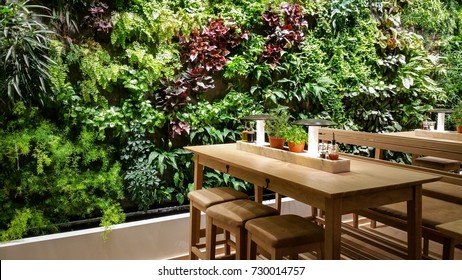 Green wall and wood table in restaurant