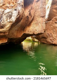 Green Water River With Rocks And Grotto On The Sides