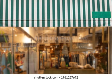 Green And White Awning Over Shop Window.