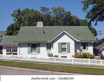 Green & White Cottage with Picket Fence