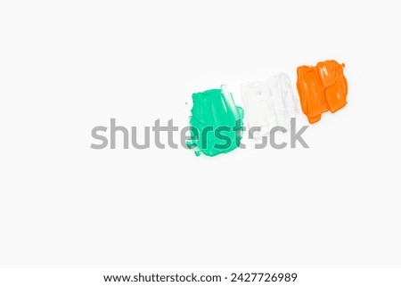 Green white and orange color paint splotches on white background. Irish flag design element for creative art and craft use