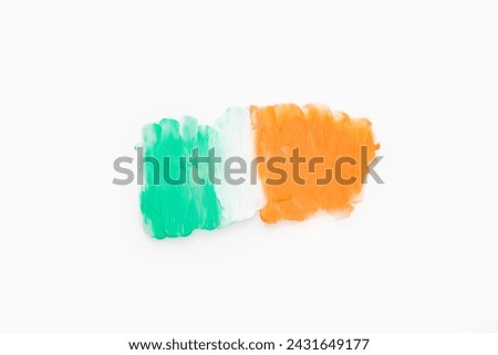Green white and orange color paint splotches on white background. Irish flag design element for creative art and craft use