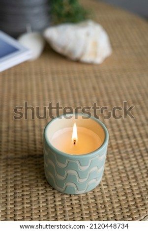 Green White Pattern Candle burning, Flames from candle alight, lit flame burning candle detail close up. Green and white calming wick alight, lit candle flame. 