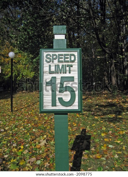 Green and\
White Speed Limit Sign: 15 Miles Per\
Hour