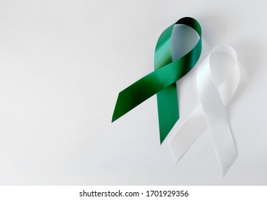 Green And White Symbolic Ribbon - The Problem Of Organ Donation, Mental Health. Teen Suicide. On A White Background