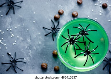 Green Witch Drink Or Jelly In Glass With Spiders, Halloween Food Idea Top View