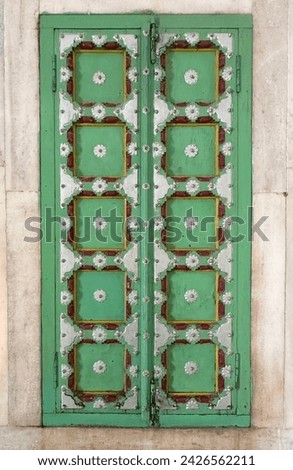 Green Wooden Door in a white marble funerary monument built in 1899 to honor Maharaja Jaswant Singh II in Jodhpur, Rajasthan, India.