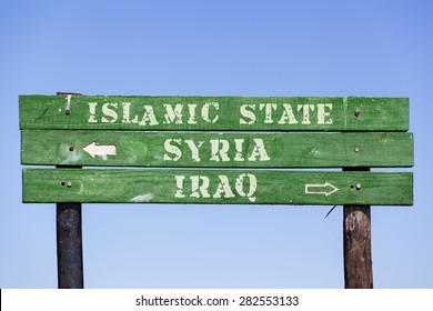 green wooden signpost with arrows showing the directions to Syria, Iraq and the Islamic State. Political concept concerning the war in  Middle East