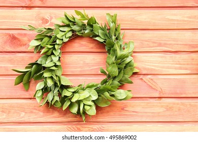 Green Wreath Hanging On Wooden Wall