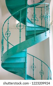 Green Wrought Iron Spiral Staircase On Indoor White Background