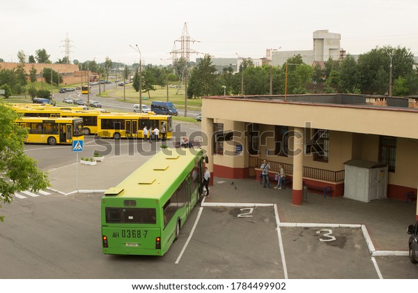 Green and yellow buses at the local small
suburban single-decker bus station, passengers get into the
transport or stand at the bus stop and wait for their bus in the
summer. Minsk, Belarus.
06/15/202