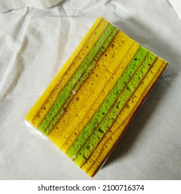 Green And Yellow Layer Cake On A White Background