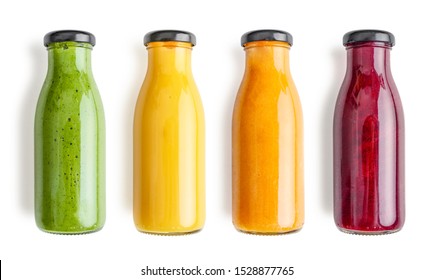 Green, yellow, orange and red smoothie in glass bottles isolated on white background, top view. Clipping path included. - Shutterstock ID 1528877765