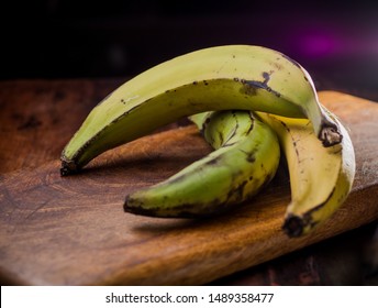 Green And Yellow Plantain / Banana On A Wooden Table. (organic Healthy Food Recipe)