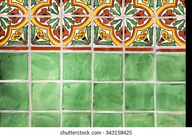 Green, yellow and red Mexican tile work on a fountain wall at the San Diego Botanical Gardens in California