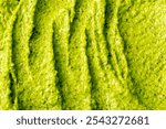 Green yogurt ice cream with pistachios, kiwi and avocado. Fresh fruit smoothie. Ice cream texture. Delicious sweet dessert close-up as background.