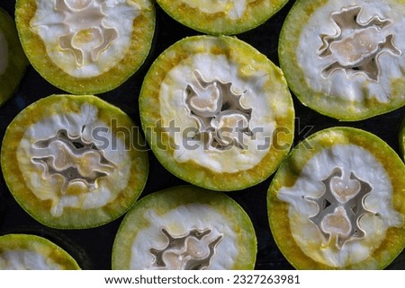 Green young walnuts cut in half, texture or background, macro, top view, close up