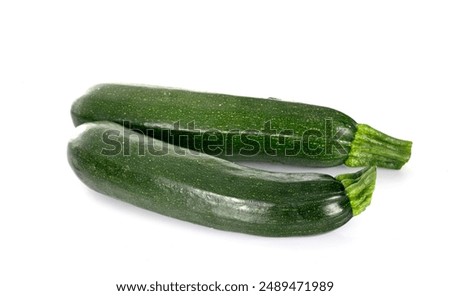 green zucchini in front of white background