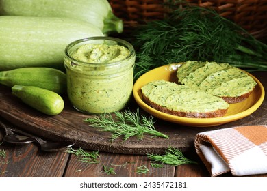 Green zucchini spread in a glass jar with whole wheat bread sandwiches on rustic dark background, healthy summer vegetarian food concept - Powered by Shutterstock