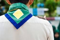 Green,blue And Yellow Frame  Scout Scarf Of Thailand Scoutmaster.And Blurry Muslim Scouts Background. Concept Is Learning Scout Subject At School Has Muslim Students.