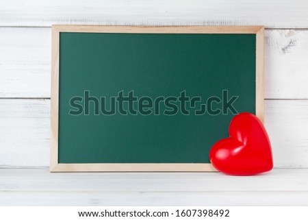 Greenboard with red heart on white wood background , empty board ,  love and  education concept with copy space.