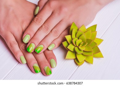 Greenery nail art light wooden background
