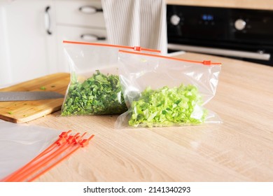 Greenery storage. Cilantro and lettuce in zip bags on the kitchen counter. - Shutterstock ID 2141340293