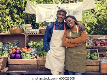 Greengrocer selling organic fresh agricultural product at farmer market - Powered by Shutterstock