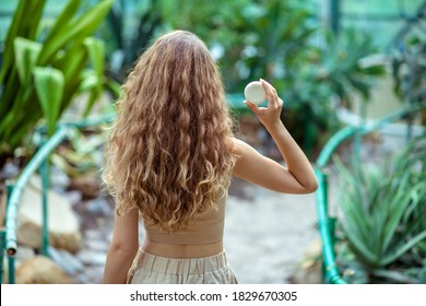 Greenhouse. Long-haired Woman With A Bar Of Sopa In Hands