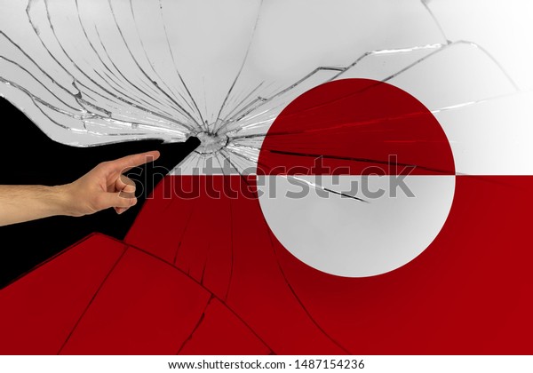 Greenland flag on a broken mirror, hand shows,\
close-up, copy space