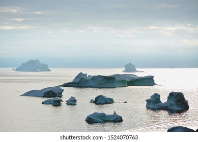 Greenland, Ilulissat, July, Disko Bay Kangia Icefjord, Jakobshavn - huge icebergs, UNESCO world heritage, beautiful nature jeopardised by climate change, melting glacier - Powered by Shutterstock