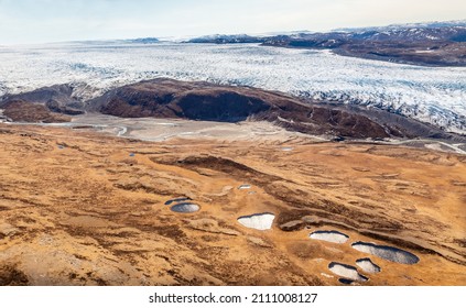 Greenlandic Ice Sheet Melting Glacier Into River With Tundra Aerial View, Near Kangerlussuaq, Greenland