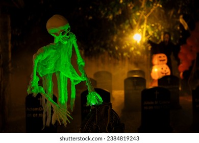 green-lighted skeleton and cemetery decoration
