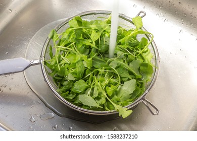 Greens In A Colander Under Running Water
