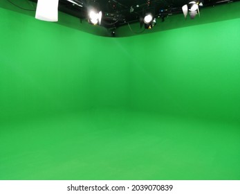 A Greenscreen Studio With Movie Lamps On The Ceiling.