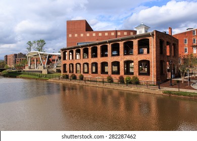 GREENVILLE, SC - MARCH 30, 2015:  Once an old paint factory, this historic building now hosts open air events in downtown Greenville on the Reedy River.