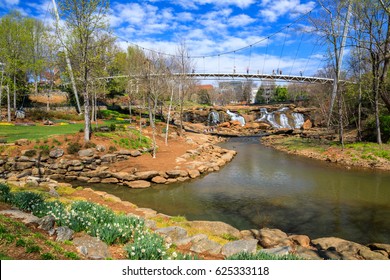 GREENVILLE, SOUTH CAROLINA - MARCH 21, 2017:  Falls Park on the Reedy River is a major tourist attraction beneath the one-of-a-kind curved pedestrian-friendly suspension Liberty Bridge downtown.