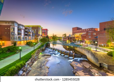 Greenville, South Carolina, USA downtown cityscape on the Reedy River at dusk.