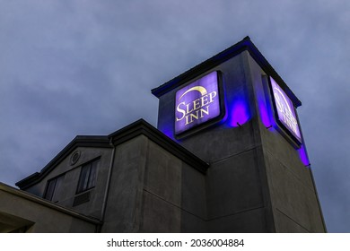 Greenville, USA - January 8, 2021: Exterior Sign At Sleep Inn Hotel Motel During Covid Coronavirus Pandemic And Creepy Blue Light And Sky At Night