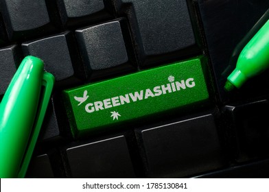 Greenwashing Concept: A Black Keyboard With A Green Marker And The Text Greenwashing. Greenwashing Is A Communication Technique To Build A False Image Of A Company In Terms Of Environmental Impact.