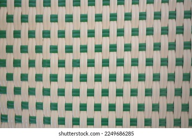 Green-white plastic weave texture pattern. It is a popular pattern for mats, baskets, or rattan furniture. Weave pattern handmade for background