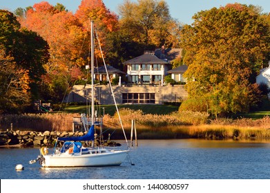 Greenwich, CT, USA October 27 A Sailboat Is Moored Off Shore Of A Waterfront Mansion In Greenwich, Connecticut