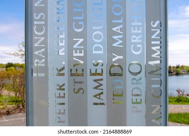 Greenwich, CT, USA-May 2022;  Close Up View Of Engraved Names In Glass Tower Of The September 11 Memorial In Cos Cob Memorial Park With Letters Of Names Horizontal Forming The Word FREEDOM