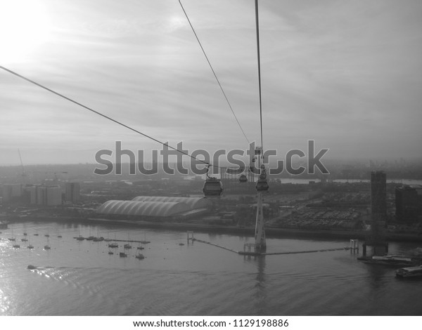 Greenwich, London, UK on 24.11.2014: The Emirates\
Air Line Ropeway across the Thames River between Greenwich\
Peninsula and Royal\
Docks