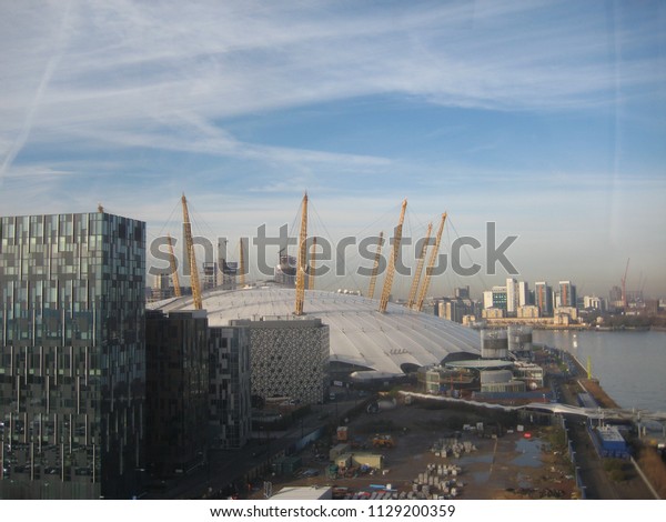 Greenwich Peninsula, London, UK on 24.11.2014: The\
O2 in front of Canary Wharf in the Eastern Part of London, taken\
from Emirates Air\
Line