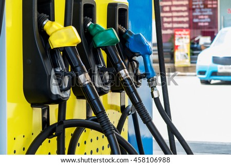 Green,Yellow and Blue fuel nozzles in the fuel dispenser in the Petrol Station