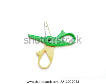 Green-Yellow scissors isolated on a white background.
